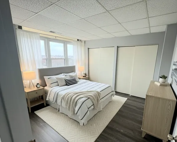 a bedroom with a bed and a flat tv screen