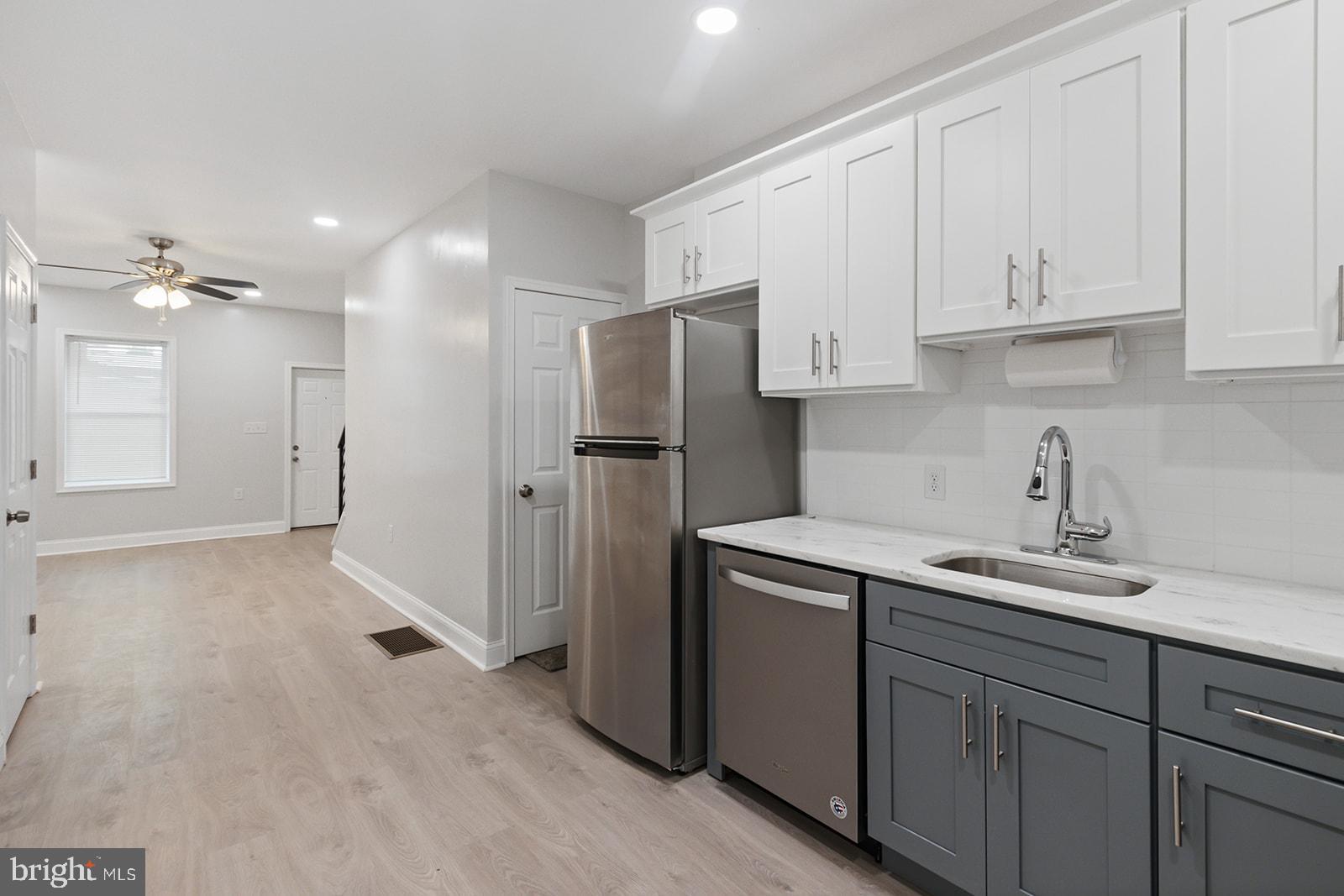 5213 Rodman Street Philadelphia, PA 19143 - Photo 11 of 31 a kitchen with a sink and refrigerator