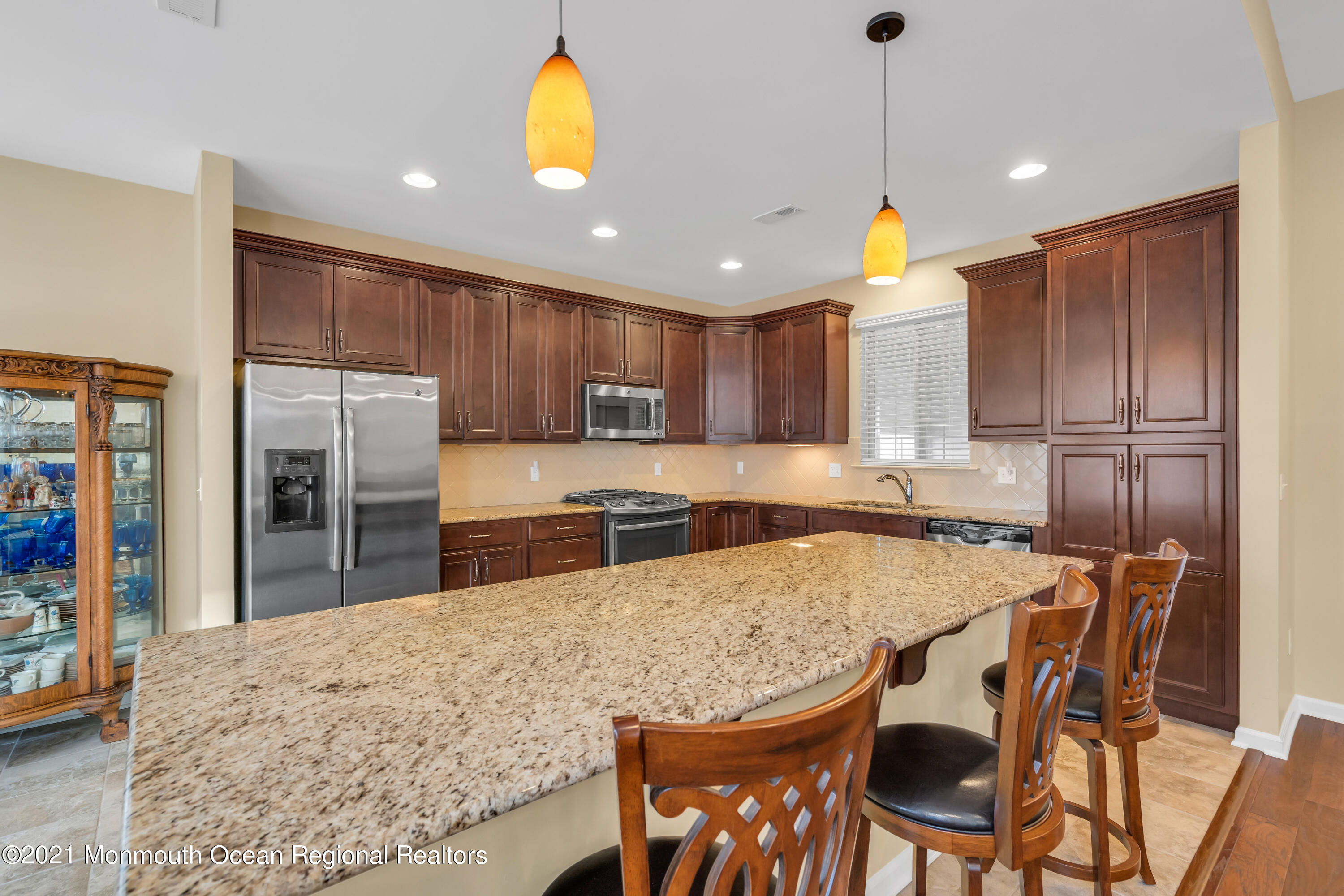 124 Heritage Point Boulevard Barnegat, NJ 08005 - Photo 21 of 56 a kitchen with kitchen island a stove a table and chairs in it
