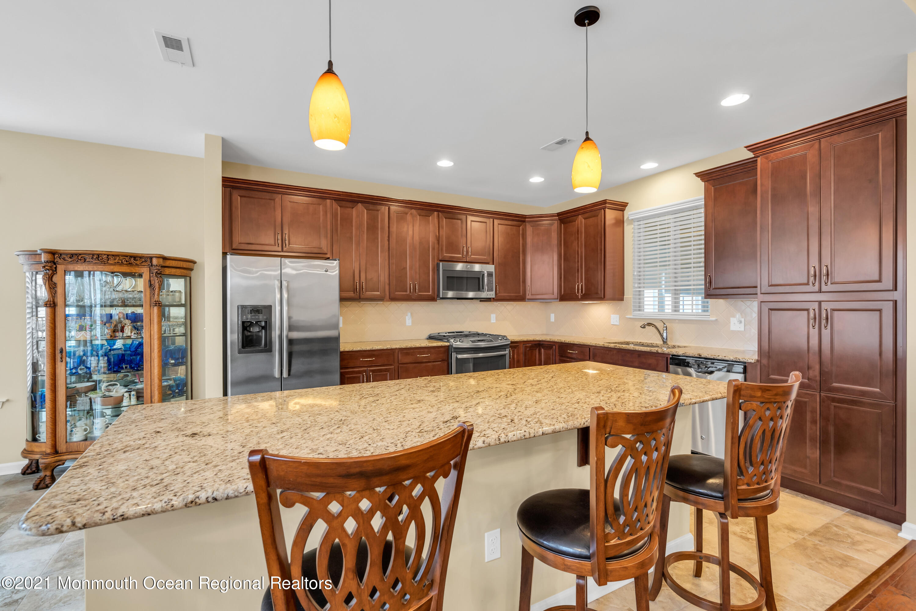 124 Heritage Point Boulevard Barnegat, NJ 08005 - Photo 23 of 56 a kitchen with stainless steel appliances granite countertop a stove top oven a refrigerator a sink and a dining table