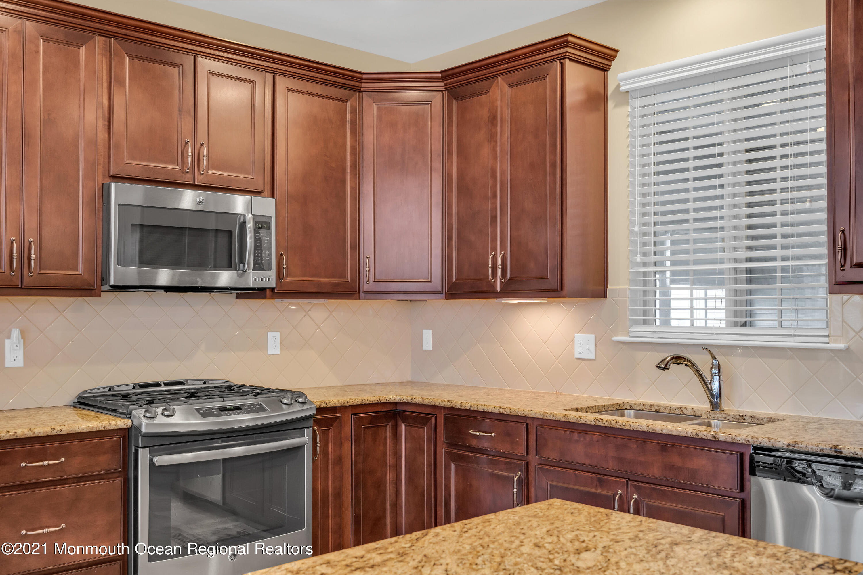 124 Heritage Point Boulevard Barnegat, NJ 08005 - Photo 24 of 56 a kitchen with sink cabinets and stainless steel appliances