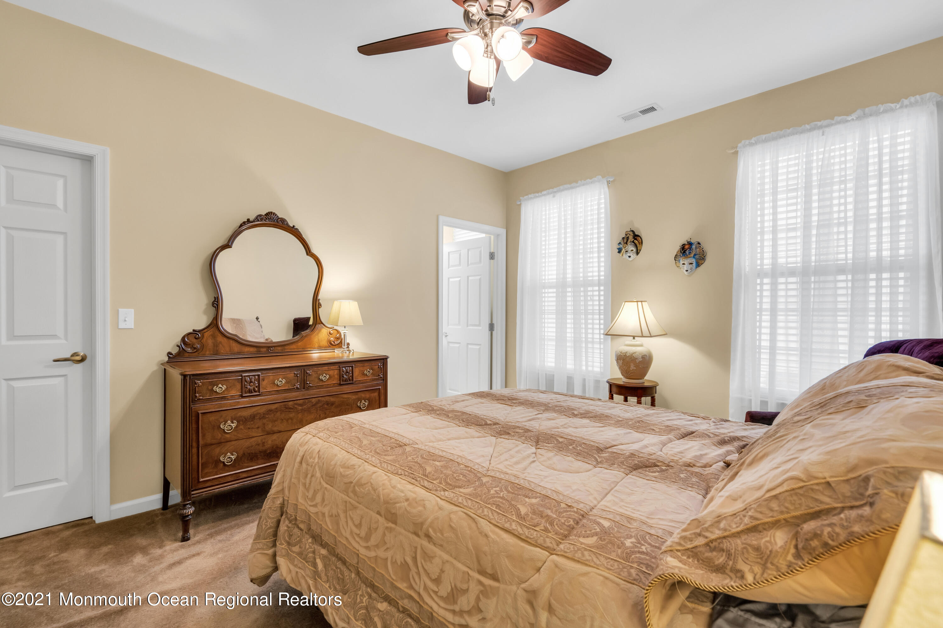 124 Heritage Point Boulevard Barnegat, NJ 08005 - Photo 34 of 56 a bedroom with a bed and a chandelier