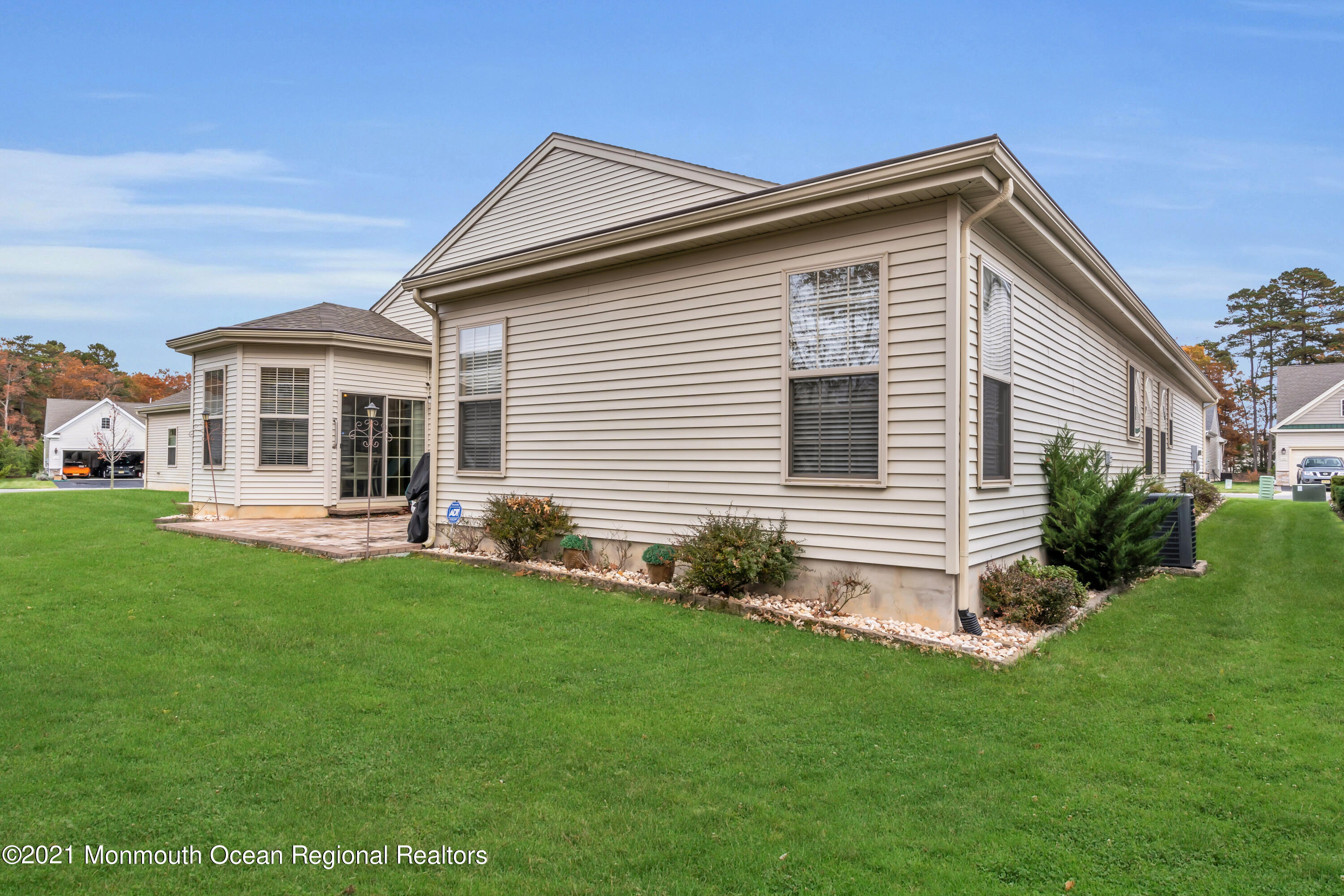 124 Heritage Point Boulevard Barnegat, NJ 08005 - Photo 43 of 56 a front view of a house with a garden and yard