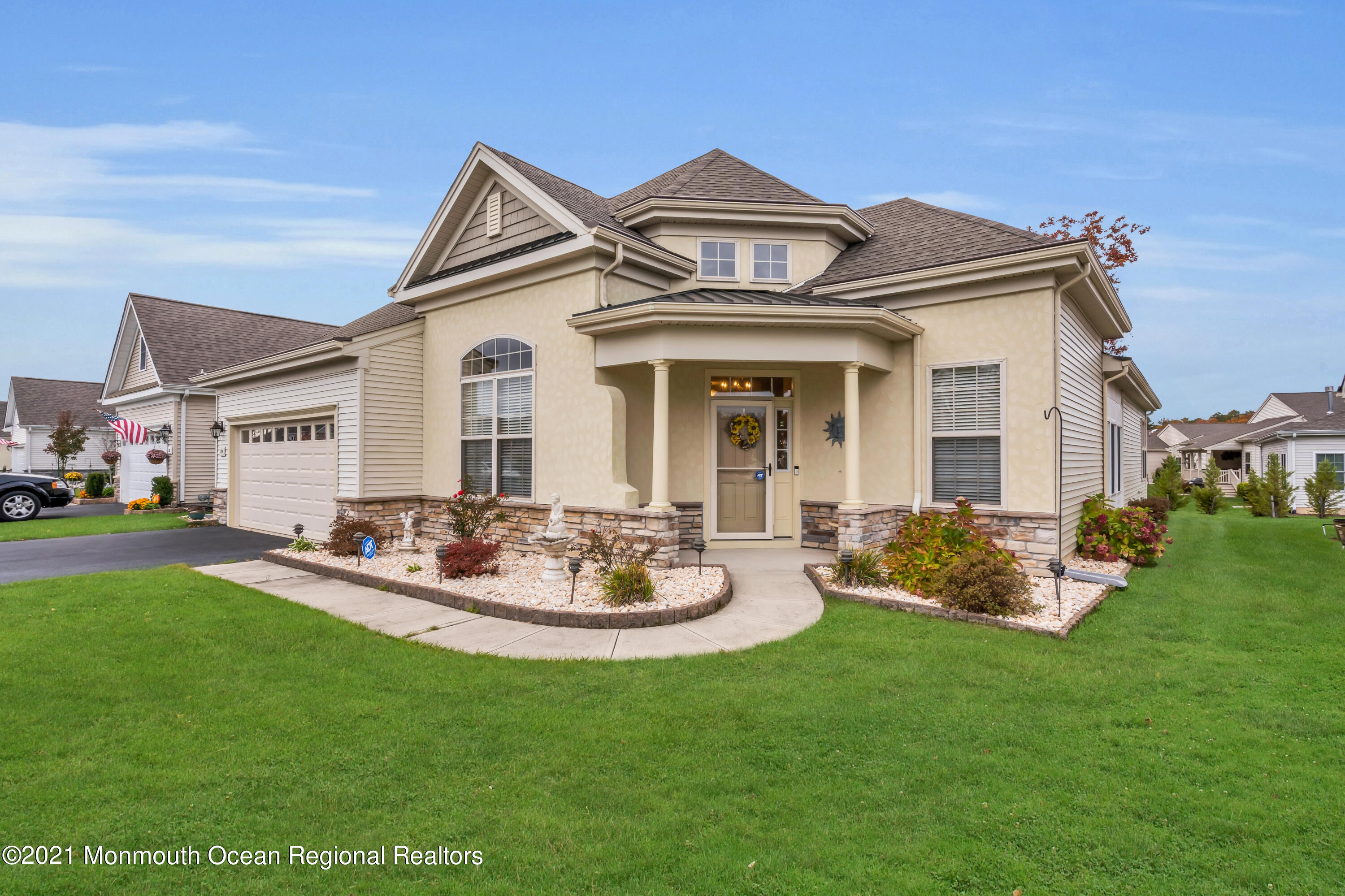 124 Heritage Point Boulevard Barnegat, NJ 08005 - Photo 48 of 56 a front view of a house with a garden and patio