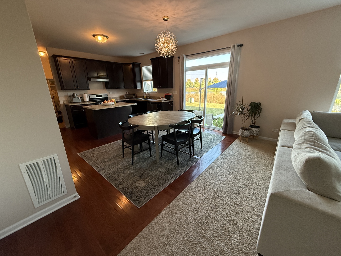 2572 Retreat Circle Lisle, IL 60532 - Photo 2 of 40 a kitchen with kitchen island granite countertop a sink dishwasher a dining table and chairs with wooden floor