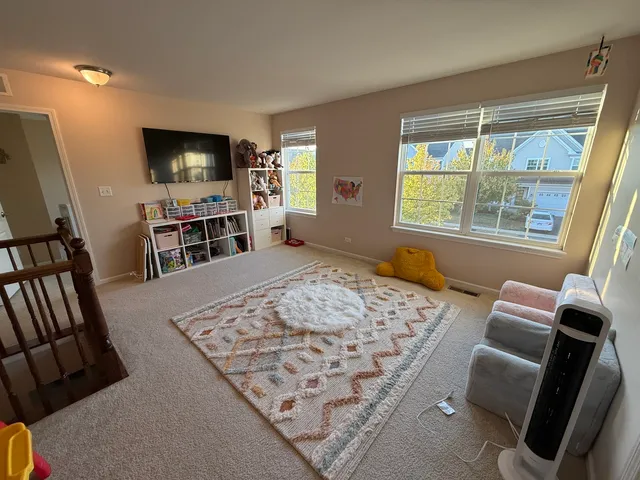 a spacious bedroom with a bed and a large window
