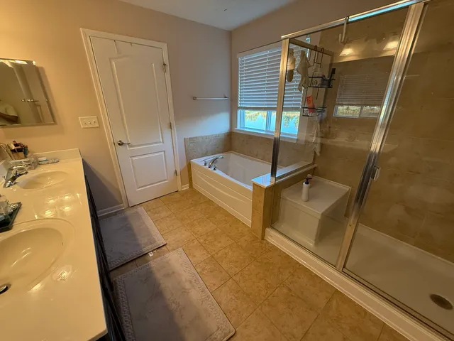 a bathroom with a double vanity sink and a mirror