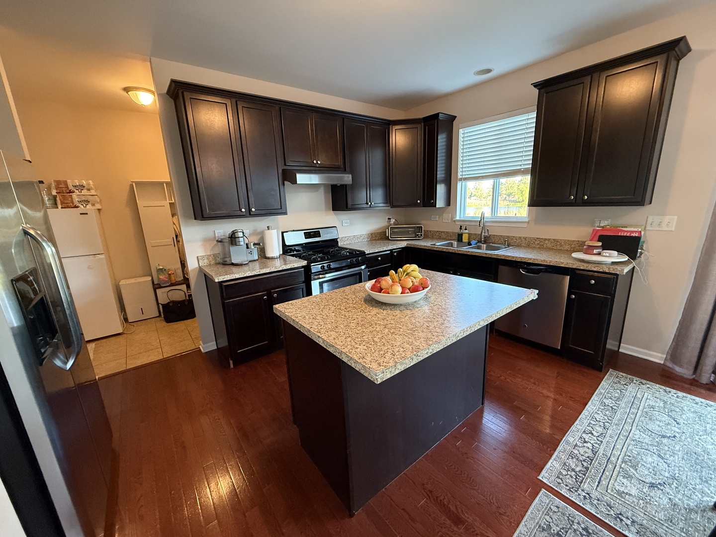 2572 Retreat Circle Lisle, IL 60532 - Photo 3 of 40 a kitchen with a sink a stove cabinets and a wooden floor