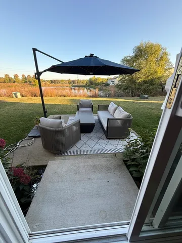 a view of a house with backyard sitting area and garden