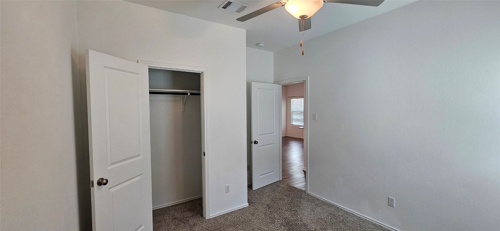 325 Geode Glen Maxwell, TX 78656 - Photo 13 of 28 an empty room with closet and a chandelier fan