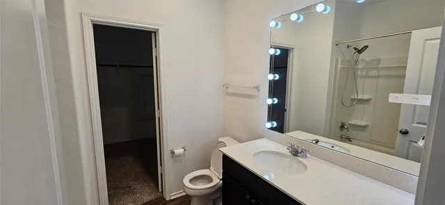 a bathroom with a sink toilet and shower