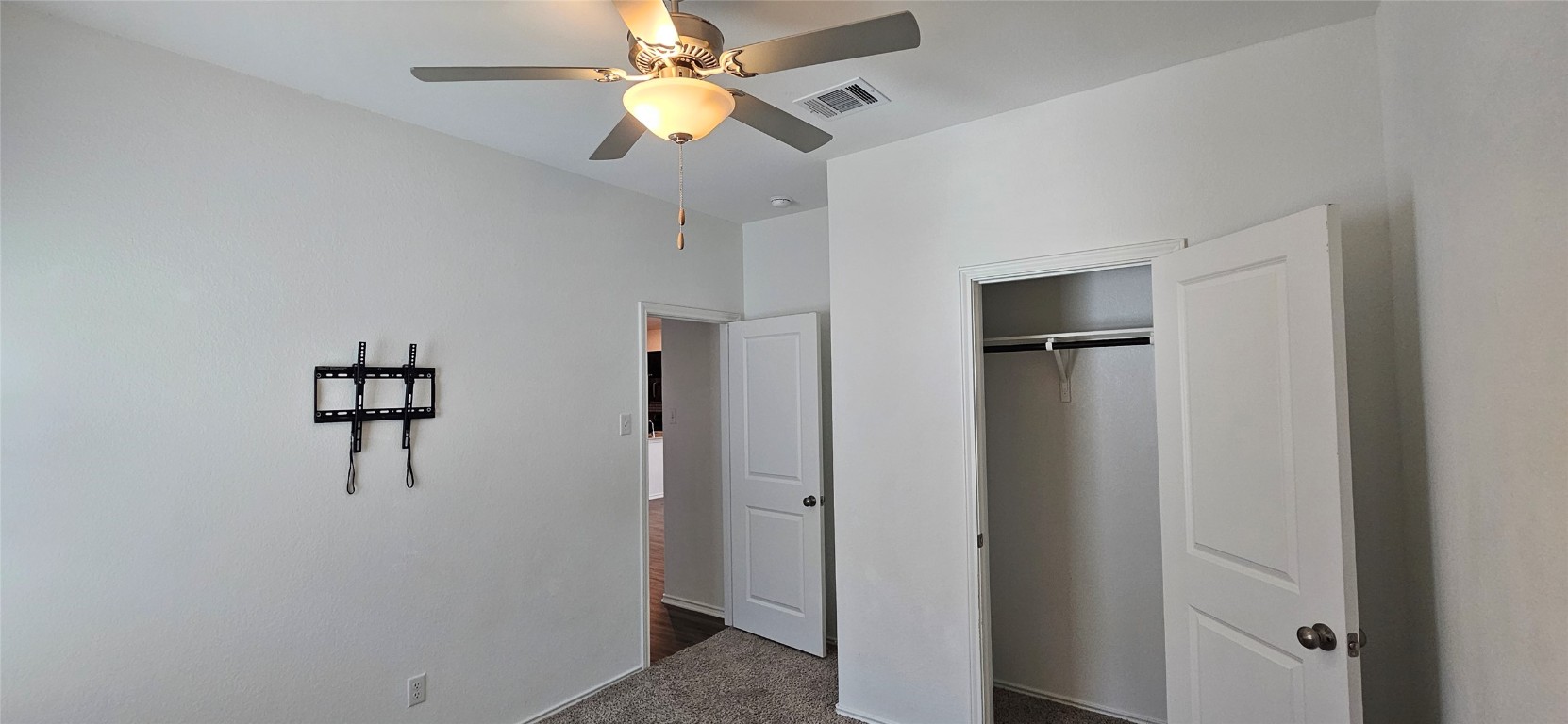 325 Geode Glen Maxwell, TX 78656 - Photo 17 of 28 a view of a hallway with closet and a chandelier fan