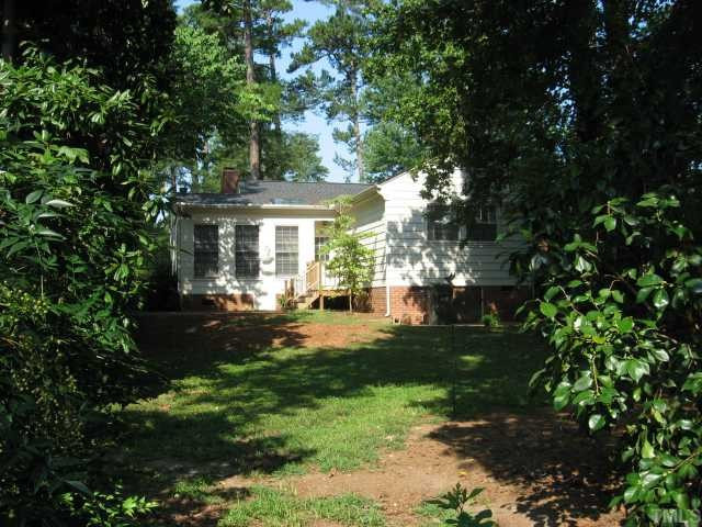1318 Dogwood Lane Raleigh, NC 27607 - Photo 10 of 11 Additional sunroom with rustic brick floor and wood stove.