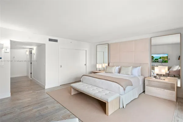 a bedroom with a bed and a couch