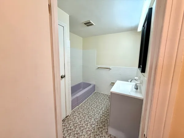 a bathroom with a sink a toilet and a mirror