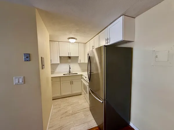 a kitchen with a refrigerator and a sink
