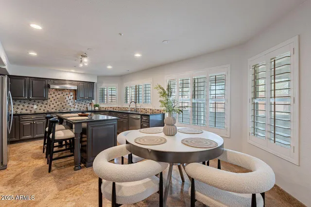 a kitchen with a table and chairs in it