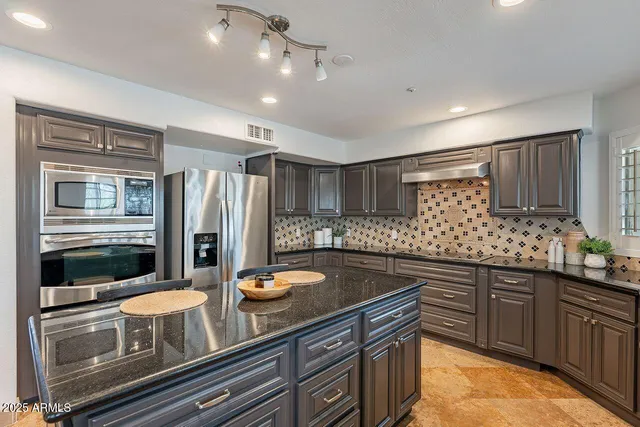 a kitchen with refrigerator and cabinets