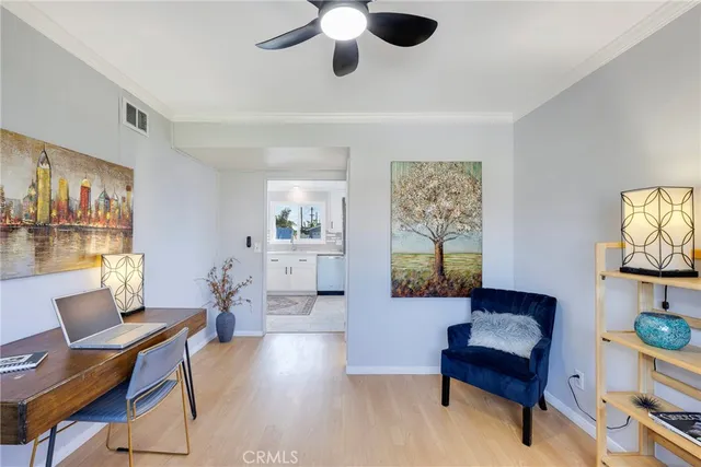 a living room with furniture and a painting on the wall