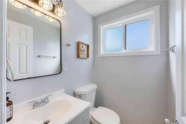 a white toilet sitting next to a bathroom sink