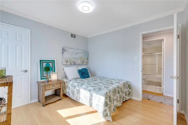 a bedroom with a bed and a potted plant