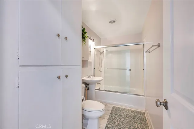 a bathroom with a sink toilet and mirror