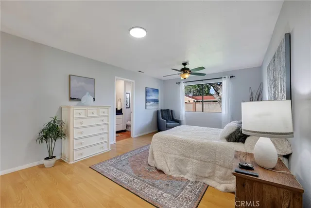 a bedroom with a bed and a lamp on a dresser