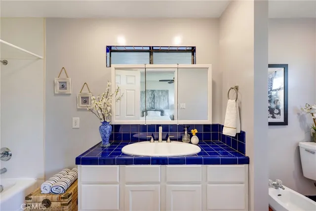 a bathroom with a toilet a sink and a mirror