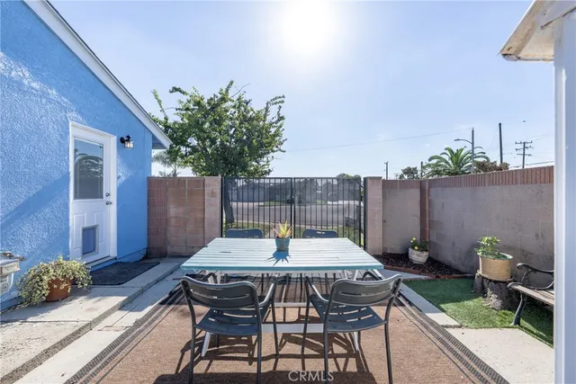 a view of a patio with a table and chairs