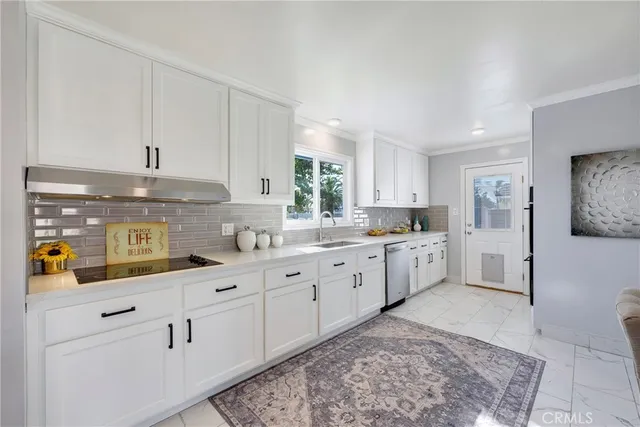 a kitchen with sink cabinets and window