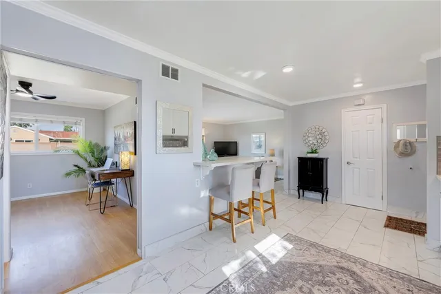 a living room with furniture and a dining table