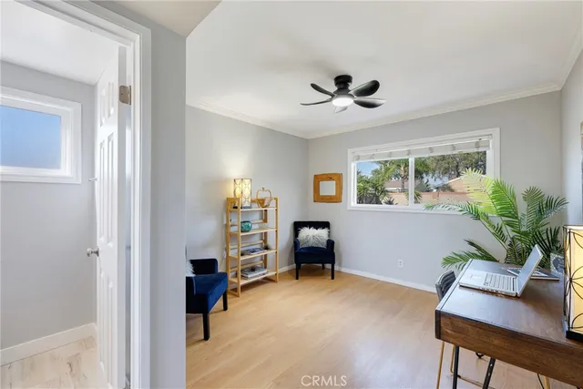 a view of a workspace with furniture and a window