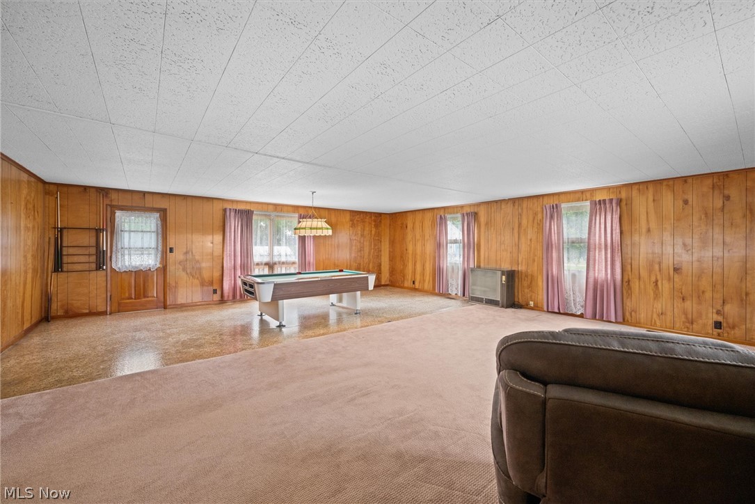 316 Deerwood Road Huron, OH 44839 - Photo 12 of 37 Carpeted family room with wood walls, plenty of natural light overlooking rec room. Side door to outdoor deck.