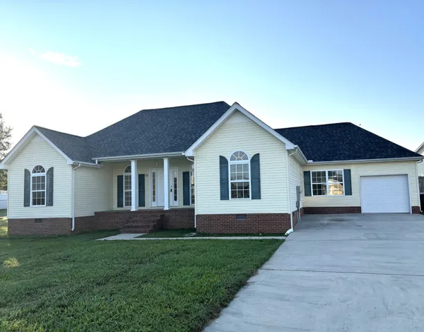 a view of a house with yard and front view of a house