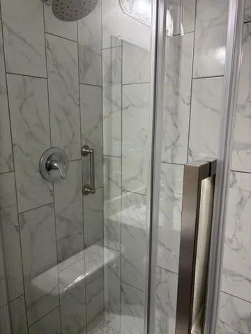 a bathroom with a shower and a toilet