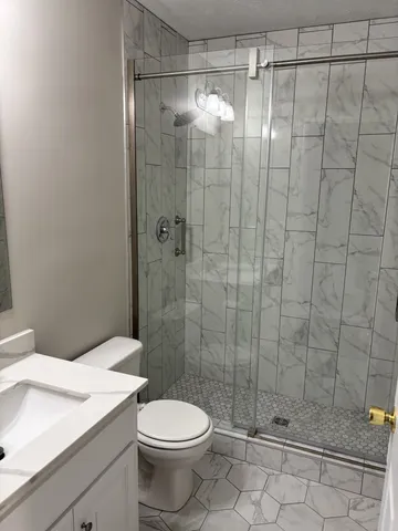 a bathroom with a glass shower door