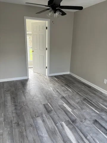 a view of a utility room with wooden floor