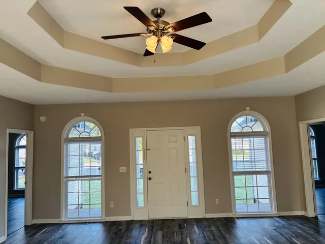 a view of an entryway with wooden floor