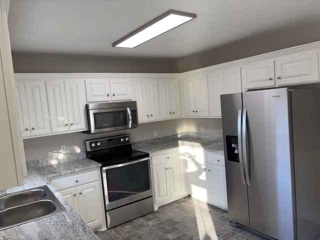 a kitchen with a refrigerator stove and microwave