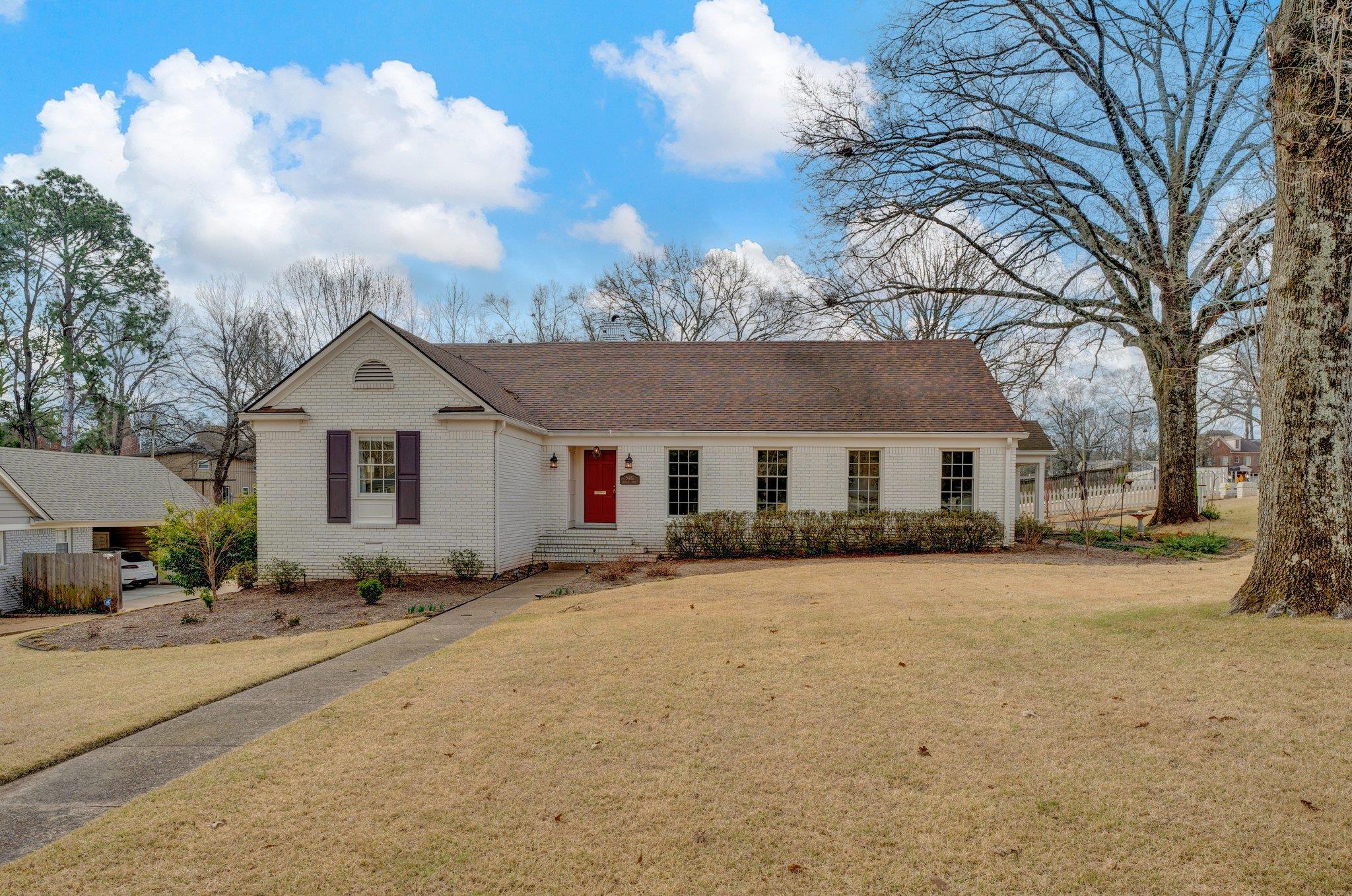 5481 Walnut Grove Road Memphis, TN 38120 - Photo 1 of 40 a front view of a house with a yard covered with snow