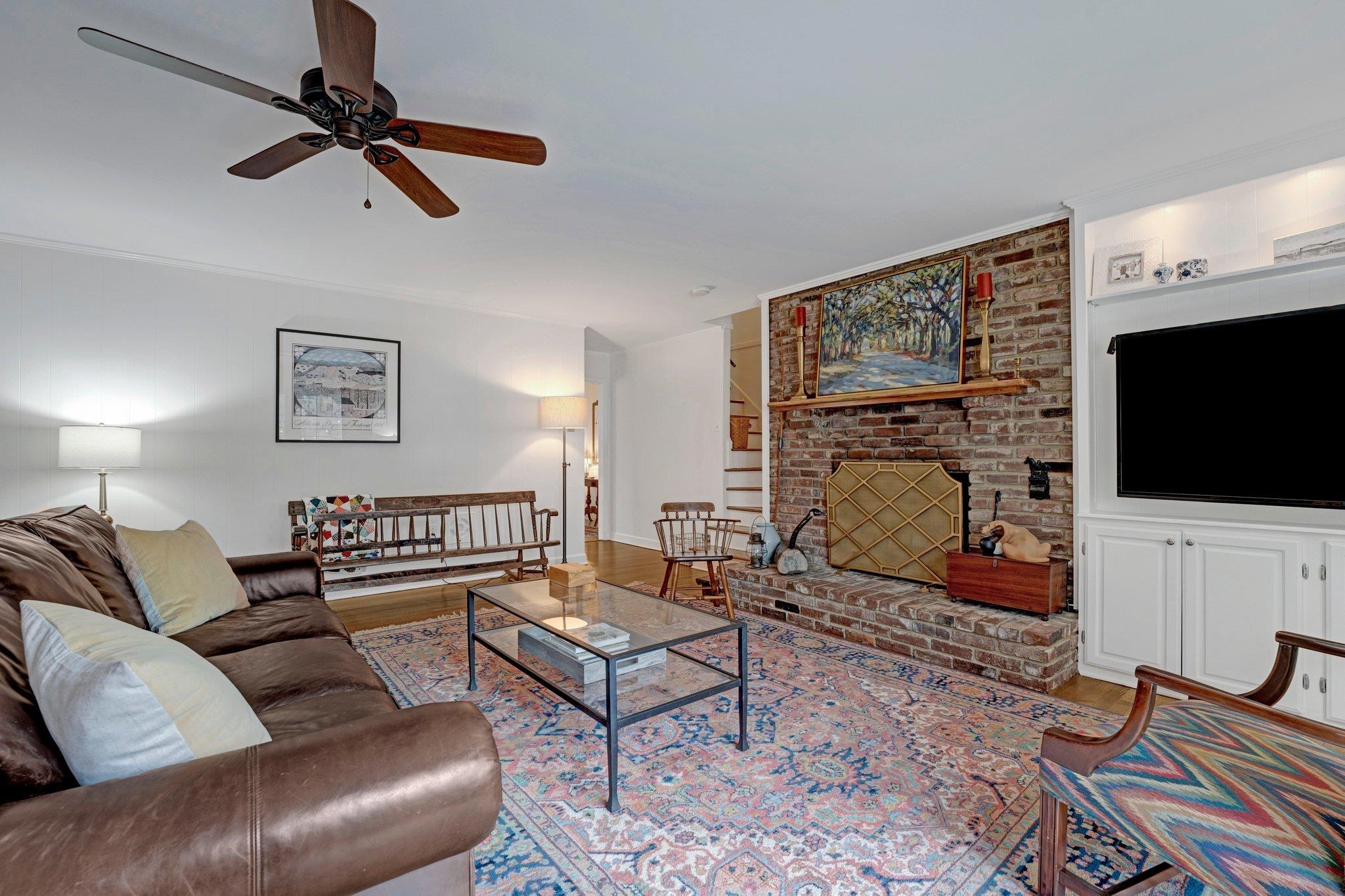 5481 Walnut Grove Road Memphis, TN 38120 - Photo 18 of 40 a living room with furniture a flat screen tv and a fireplace