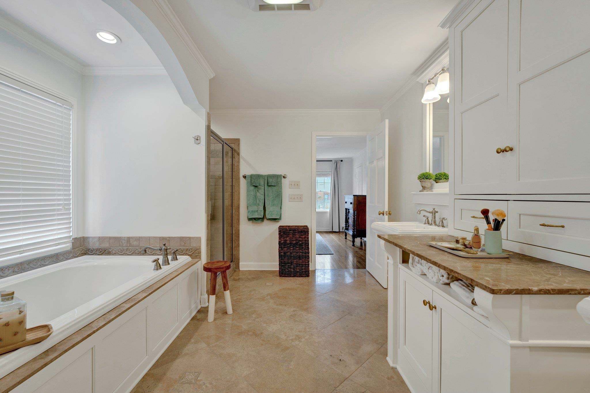 5481 Walnut Grove Road Memphis, TN 38120 - Photo 30 of 40 a spacious bathroom with a granite countertop tub sink and mirror