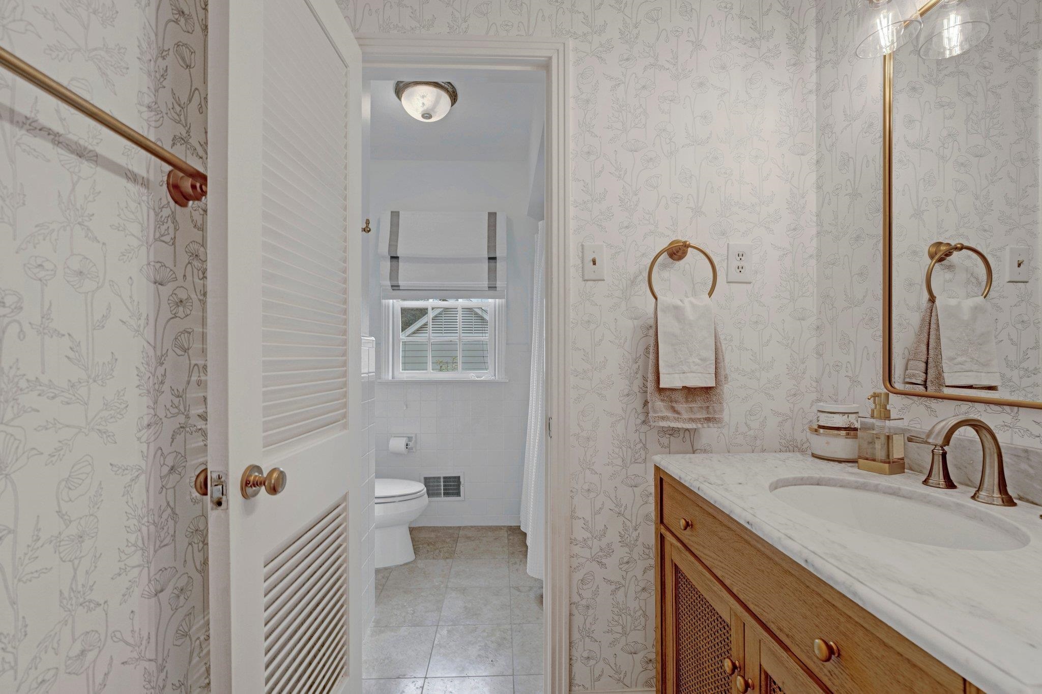 5481 Walnut Grove Road Memphis, TN 38120 - Photo 32 of 40 a bathroom with a sink a toilet a mirror and shower