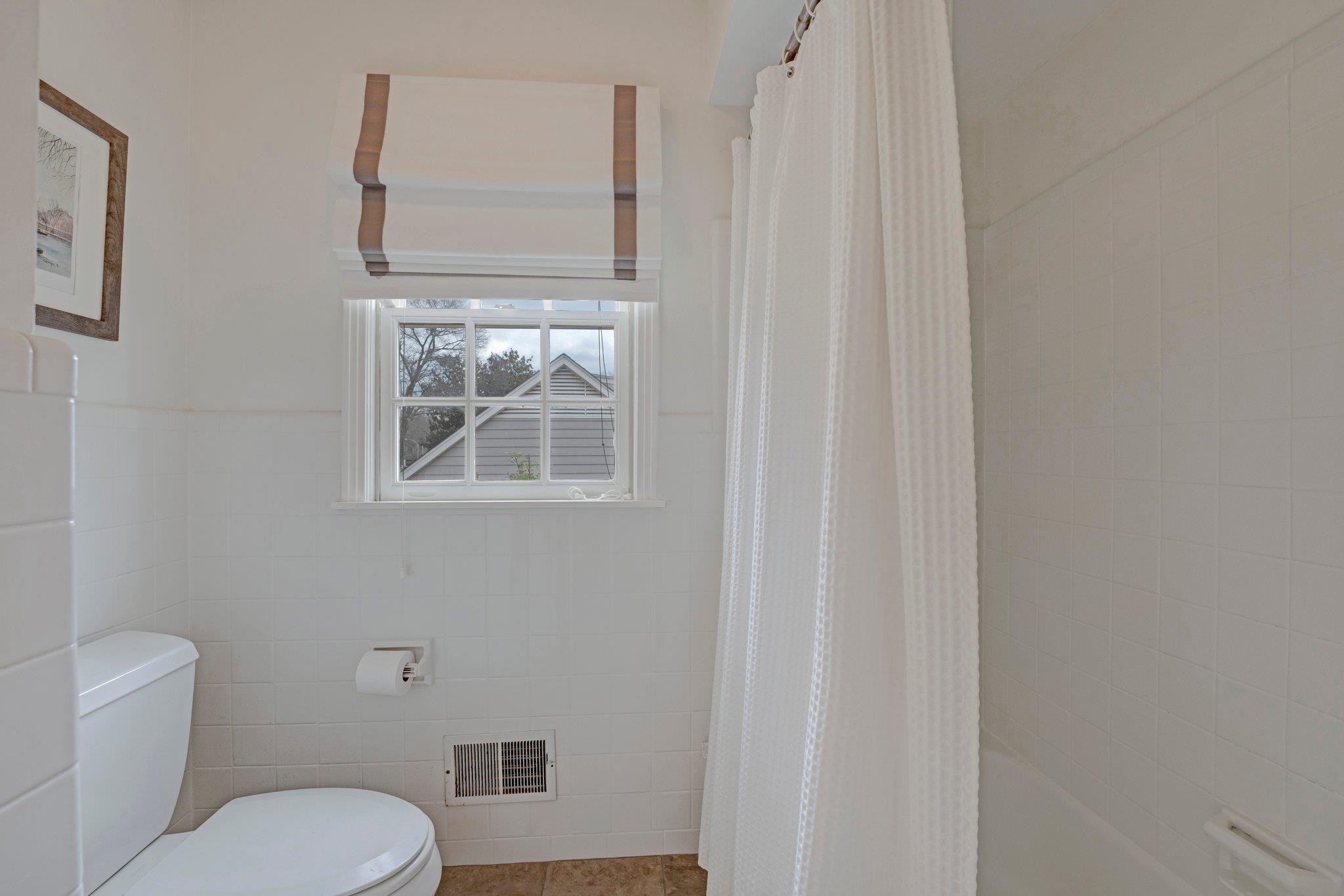 5481 Walnut Grove Road Memphis, TN 38120 - Photo 33 of 40 a bathroom with a toilet a sink and a window