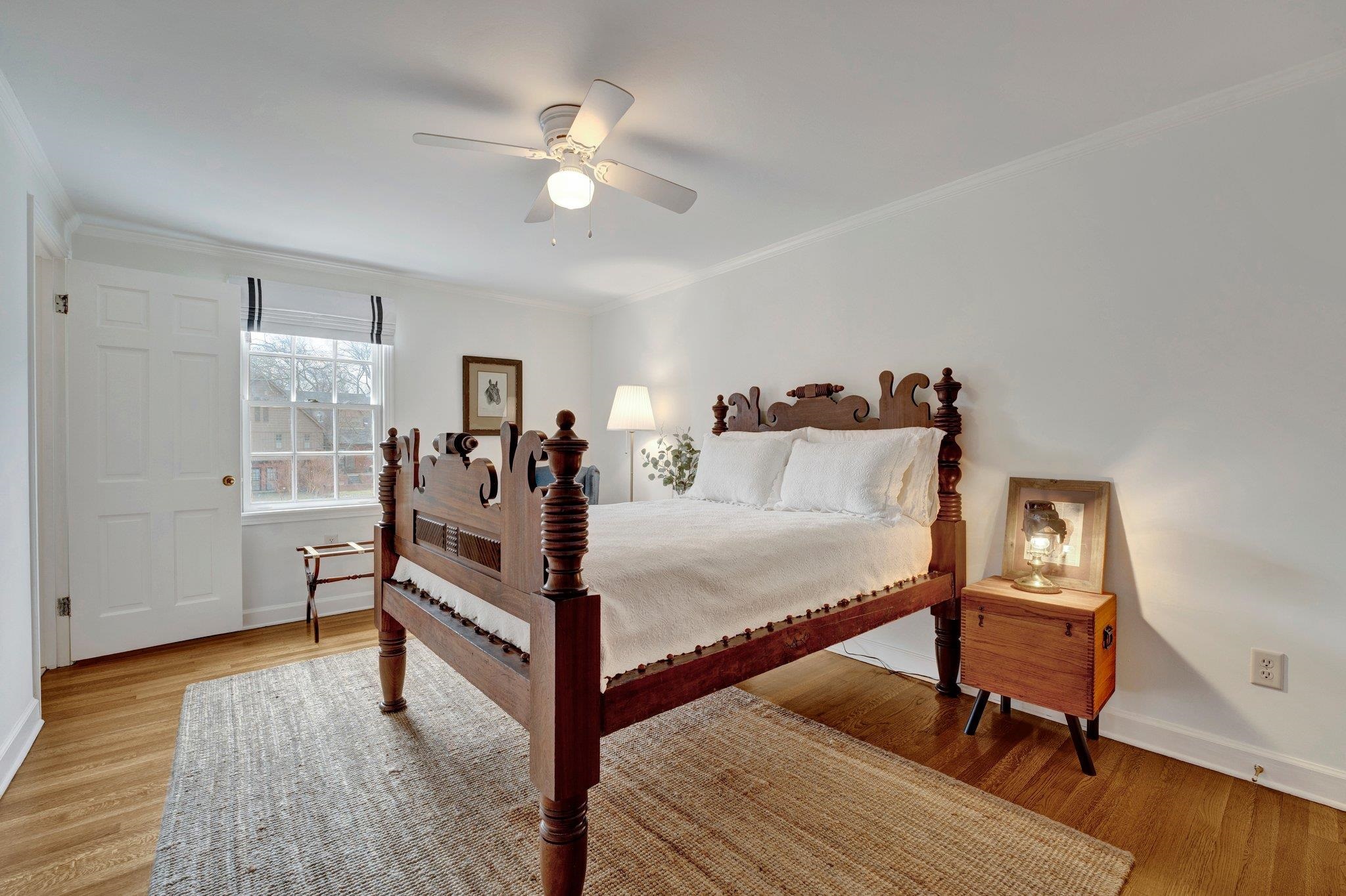 5481 Walnut Grove Road Memphis, TN 38120 - Photo 34 of 40 a bed room with a bed and a chandelier