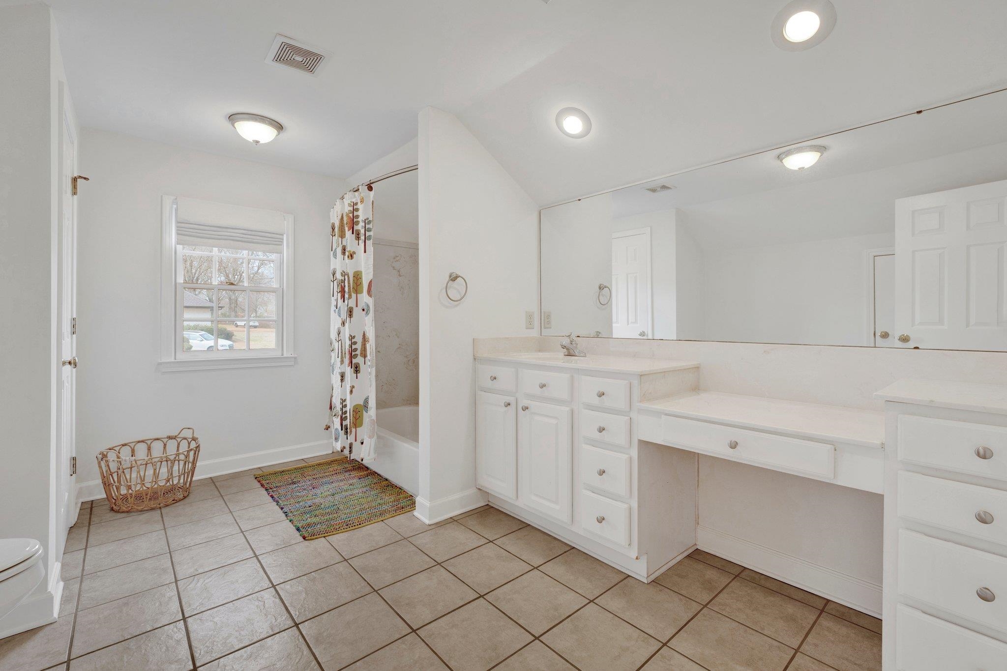 5481 Walnut Grove Road Memphis, TN 38120 - Photo 37 of 40 a spacious bathroom with a mirror sink and view