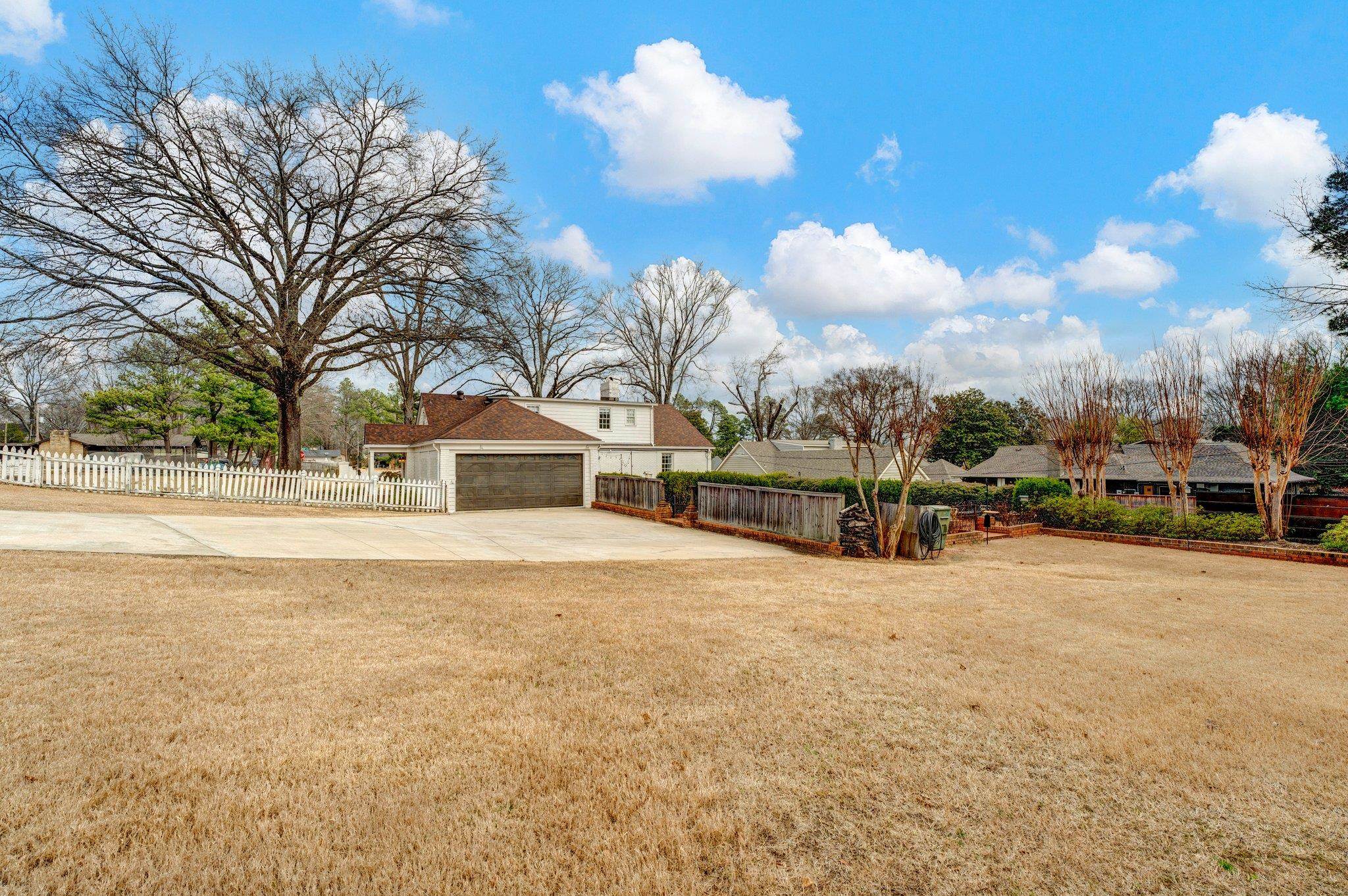 5481 Walnut Grove Road Memphis, TN 38120 - Photo 40 of 40 a front view of a house with a yard and garage