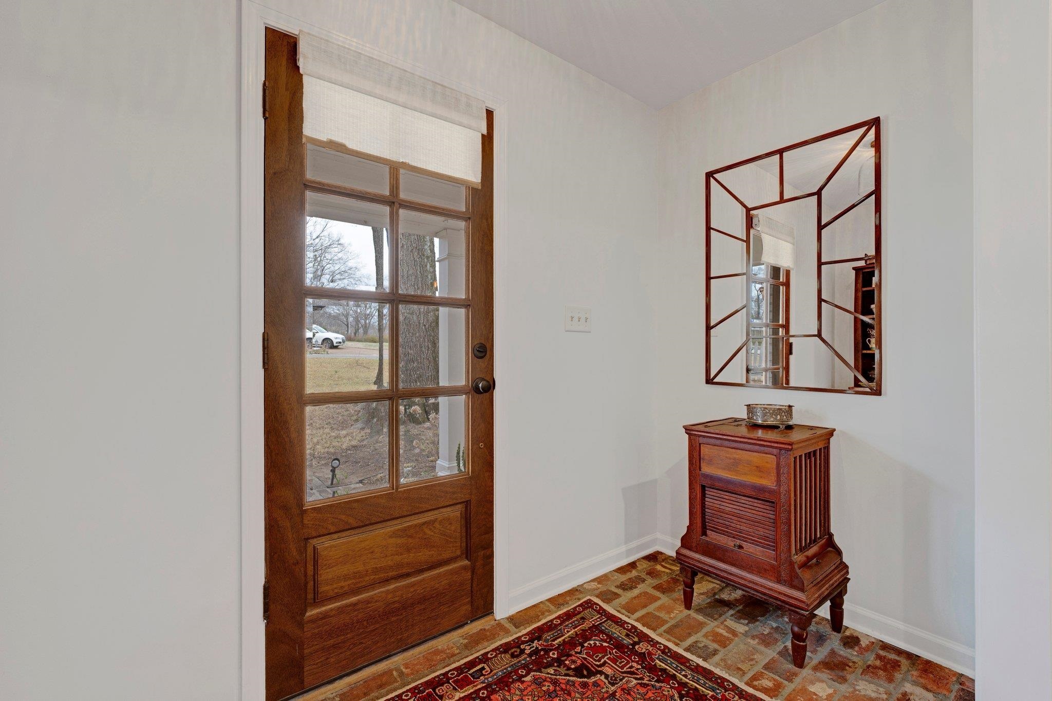 5481 Walnut Grove Road Memphis, TN 38120 - Photo 9 of 40 a room with a bench and paintings on wall