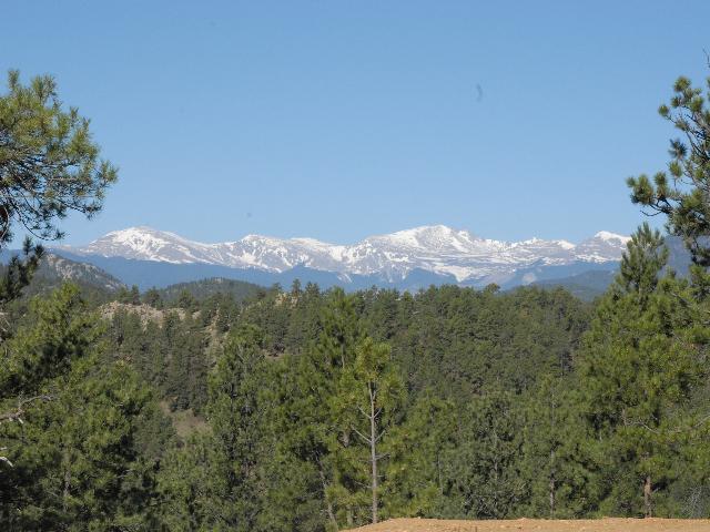 2999 Highlands View Road Evergreen, CO 80439 - Photo 1 of 1 a view of a mountain range with trees in the background