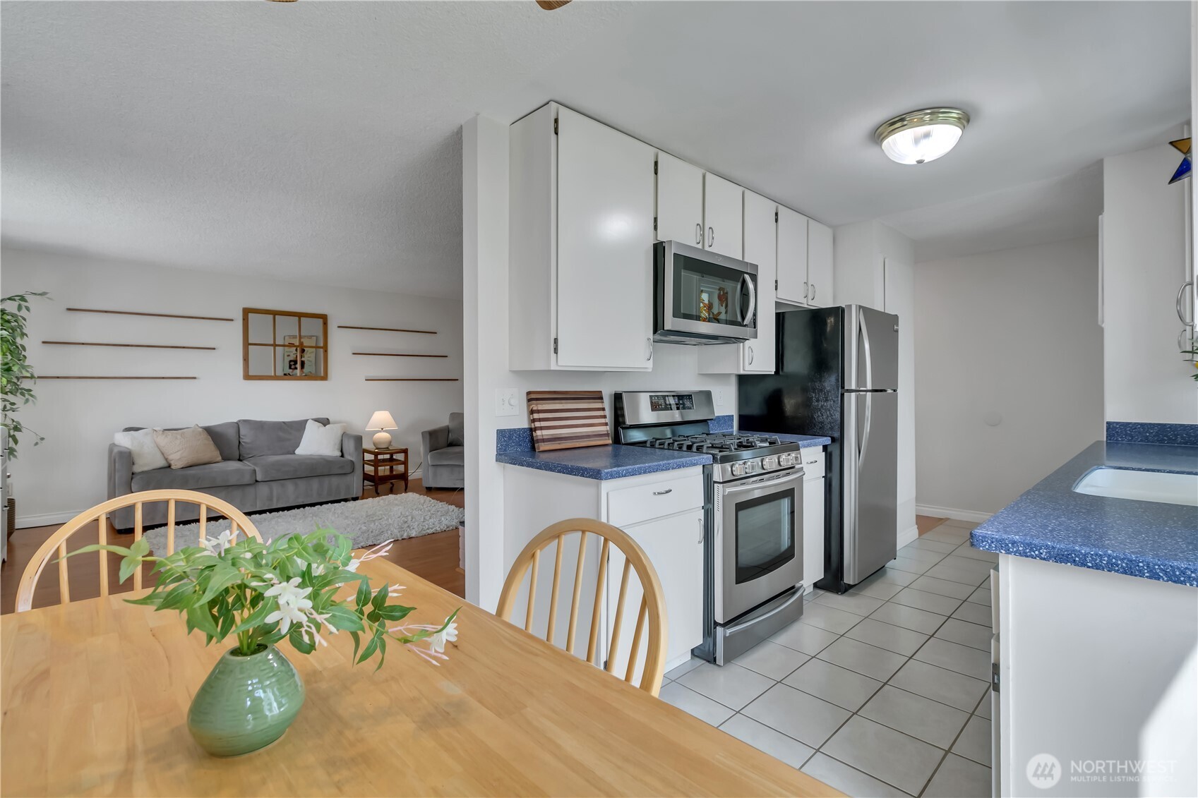 131 South 324th Place Federal Way, WA 98003 - Photo 2 of 24 a kitchen with stainless steel appliances kitchen island granite countertop a refrigerator a stove a microwave a sink and dishwasher